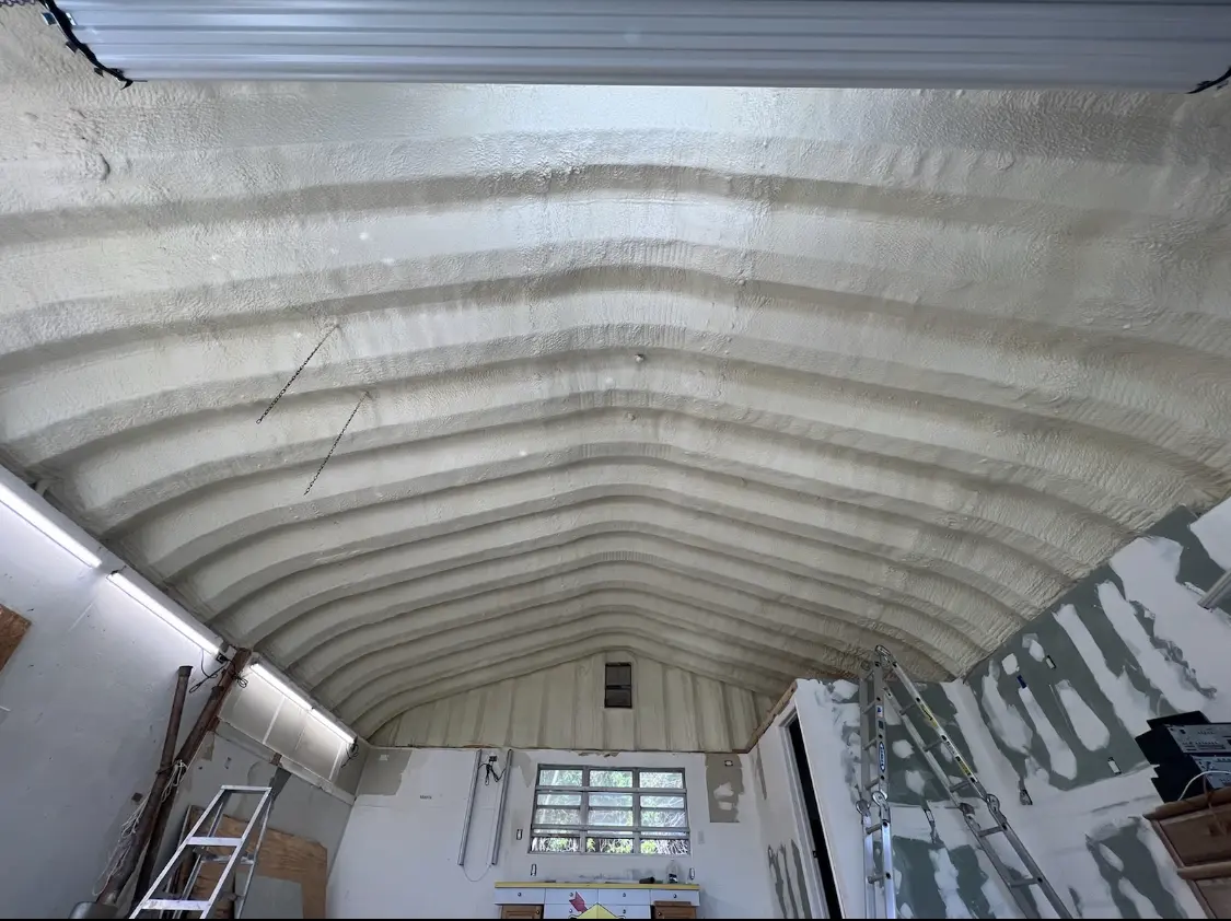 Spray polyurethane foam applied to the underside of a metal roof deck in Brownstown
